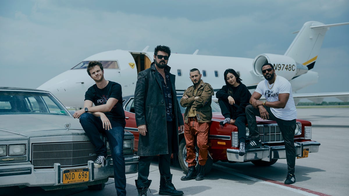 Butcher and The Boys look cool lounging on cars in front of a private jet.