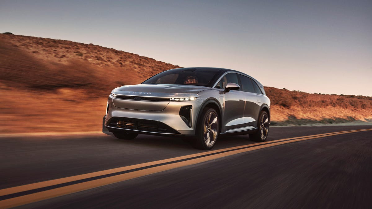 quarter view of silver 2025 Lucid Gravity Electric SUV speeding through a desert
