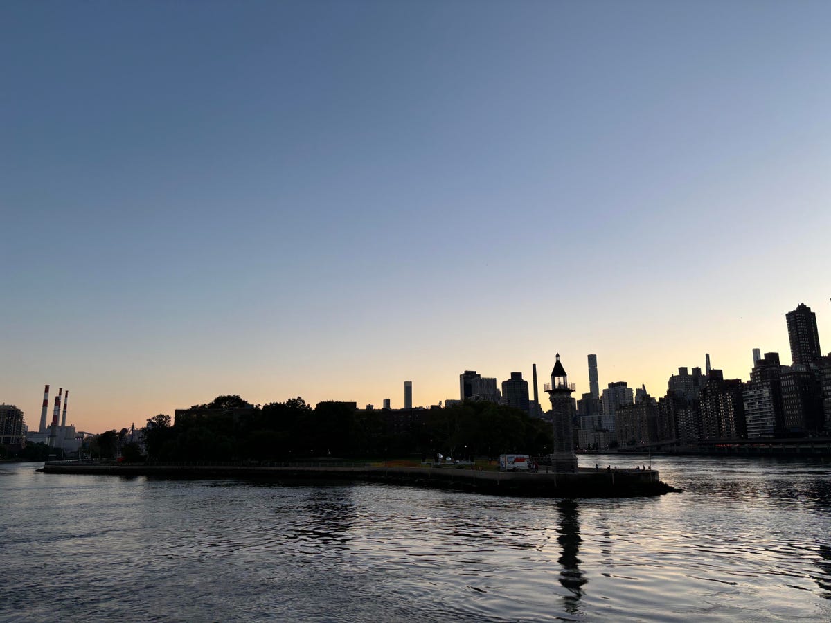A photo of a silhouette of buildings on the water taken on the iPhone 15