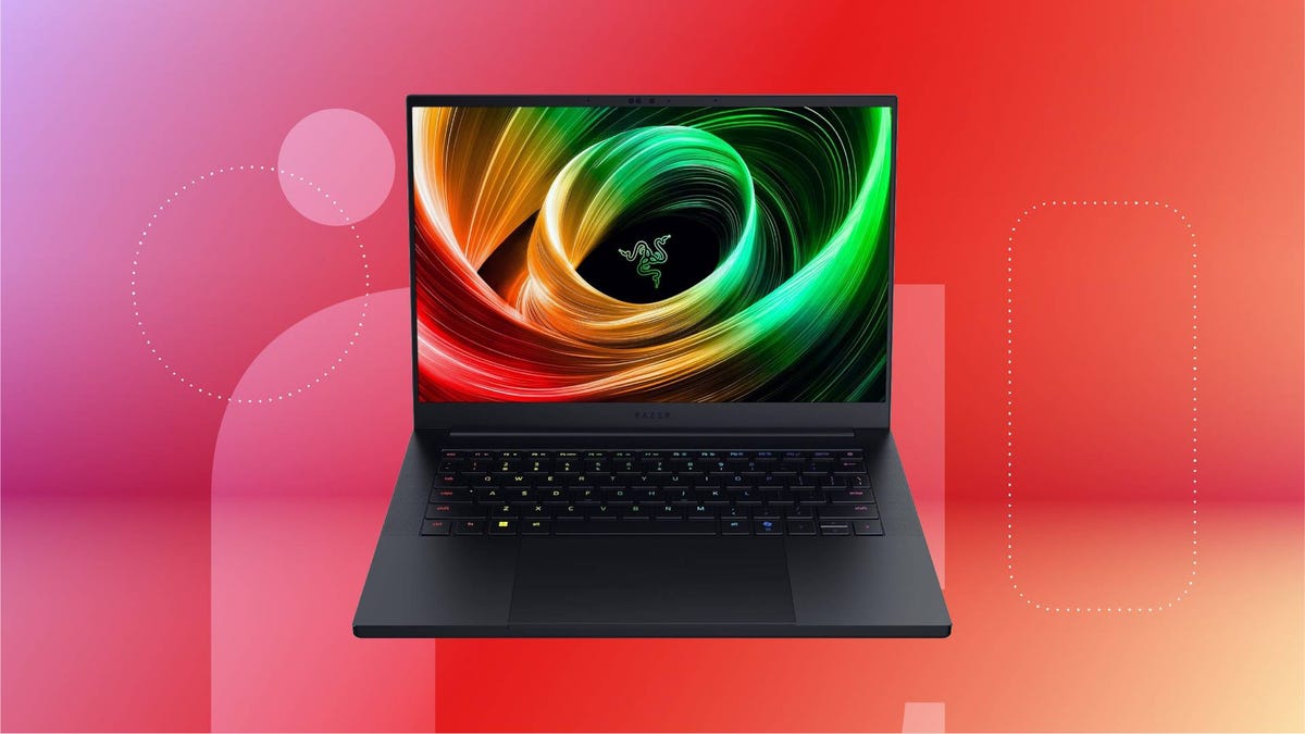 An open black laptop against a red gradient CNET background.