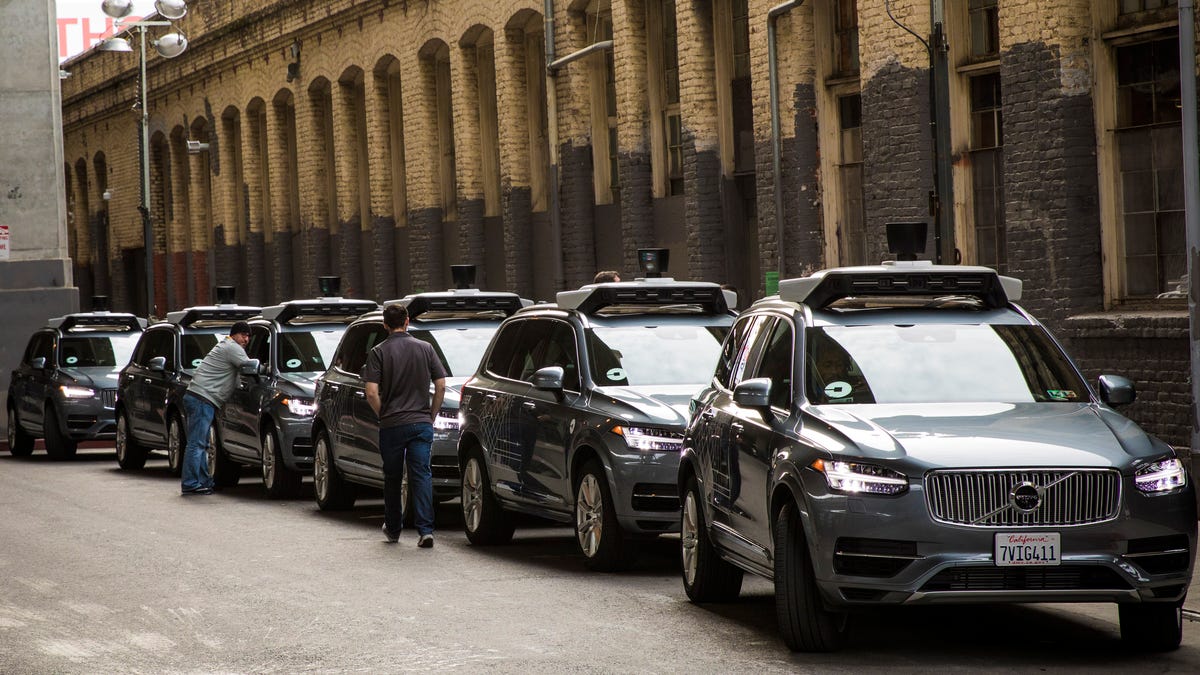 A line of Volvo XC90 crossover SUVs, modified by Uber to function as self-driving cars.