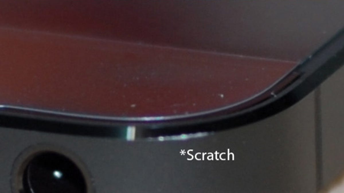 This image from MacRumors forum user MMM.PWR shows a scratch on the bottom corner of a new iPhone 5.