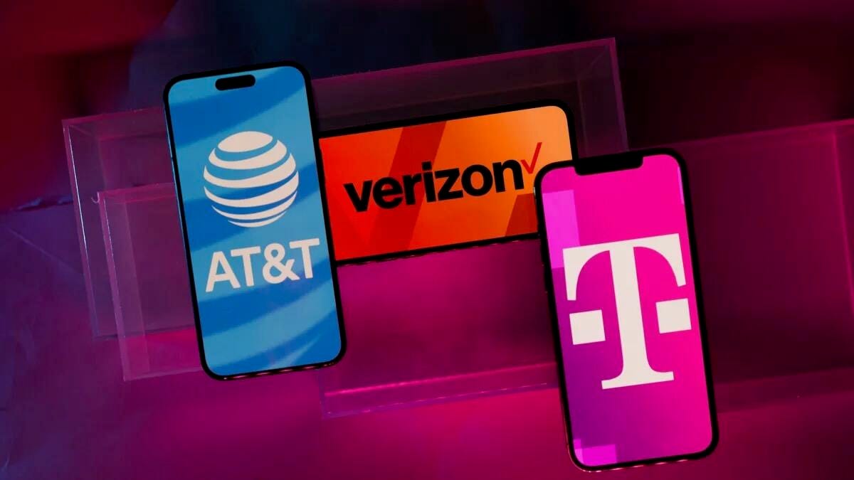 Three phones displaying the AT&T, Verizon and T-Mobile logos against a red and purple geometric background.