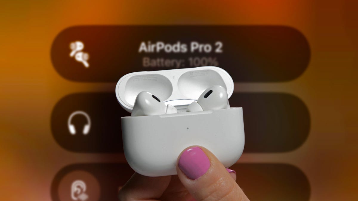 Hand holding the airpods in an open charging case against a screenshot of airpods features