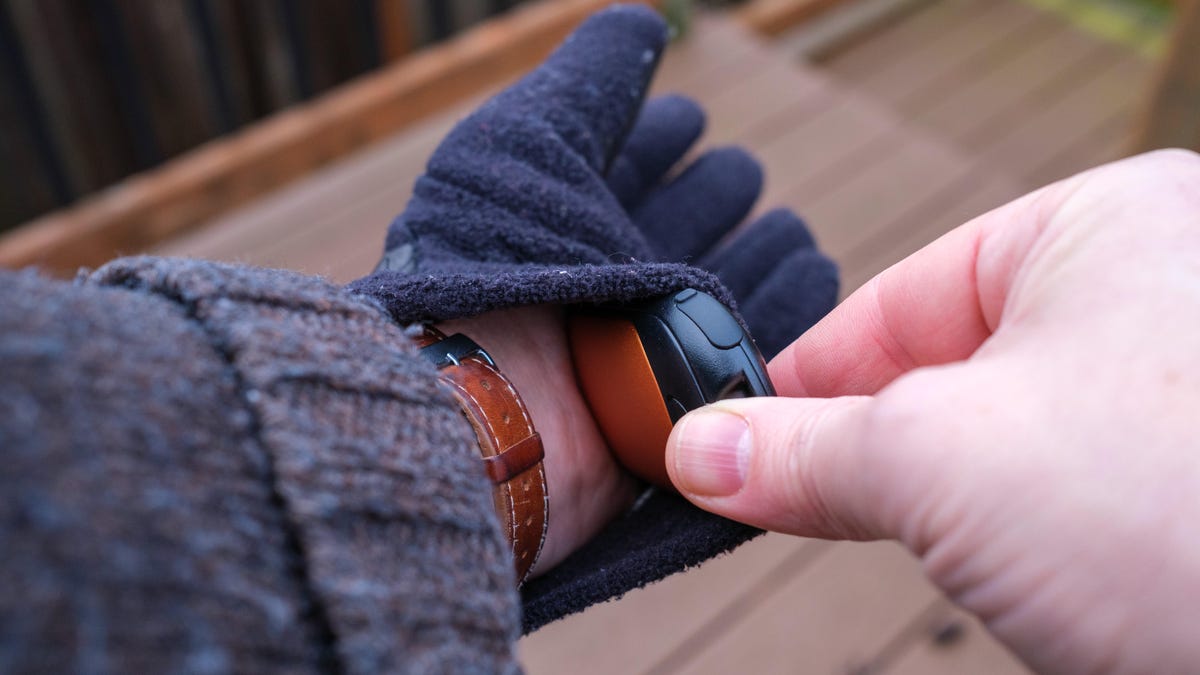 Putting a hand warmer into a glove.