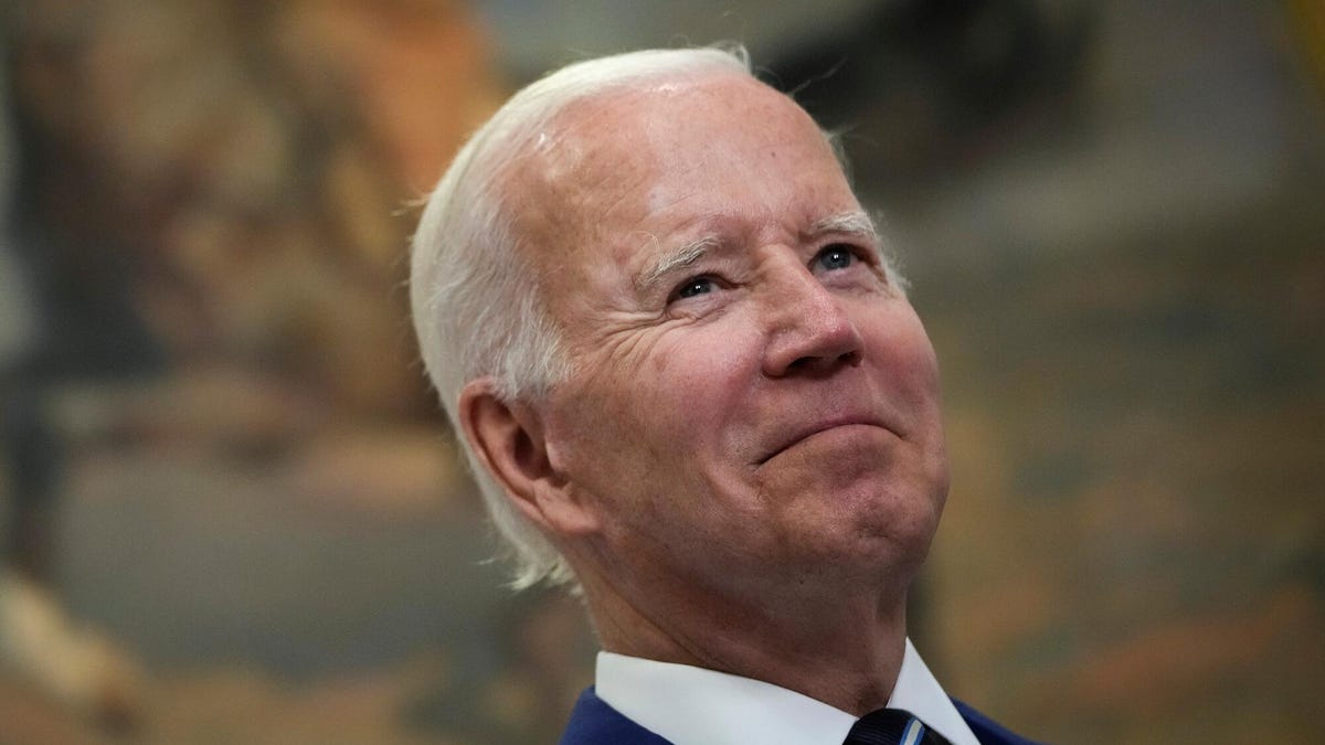 Joe Biden smiles and gazes upward