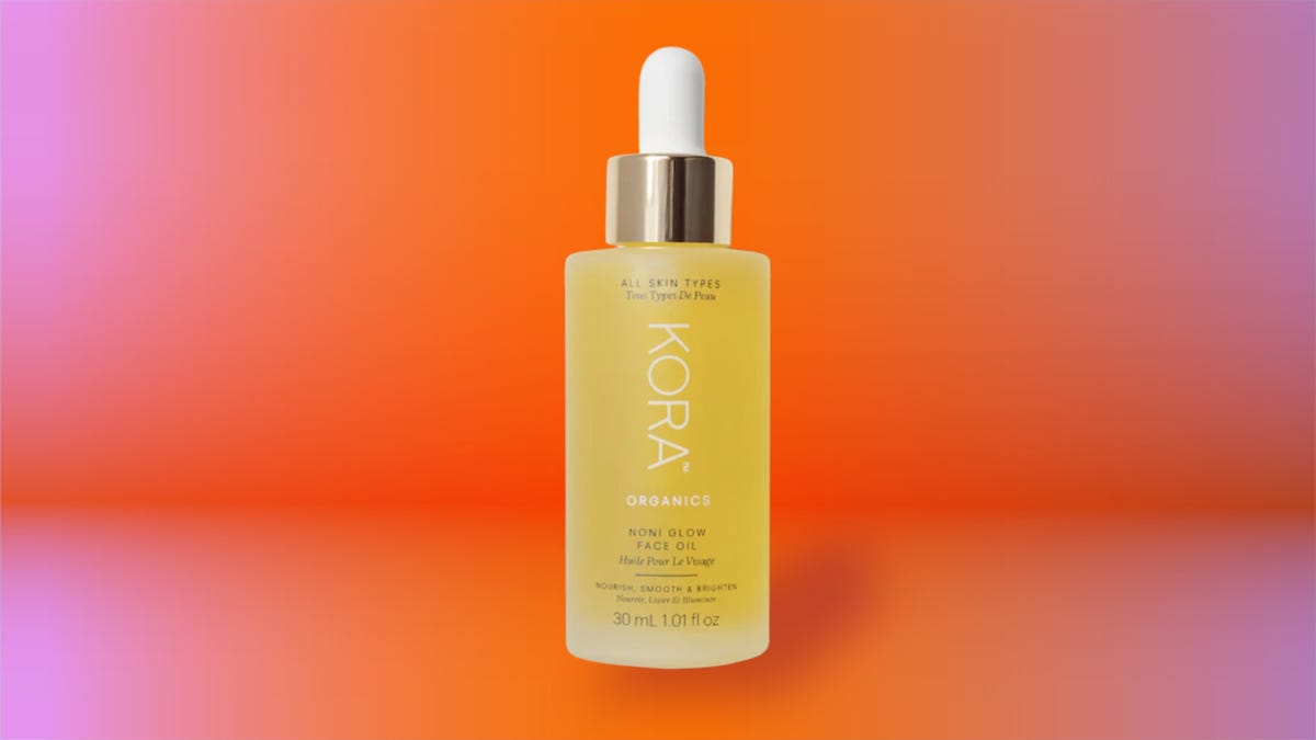 Kora Organics face oil against a coral background