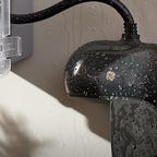 GE Cync's outdoor outlet wet against siding.