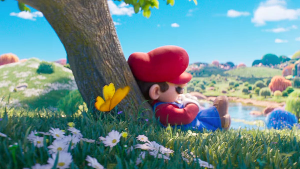 mario is sleeing under a tree