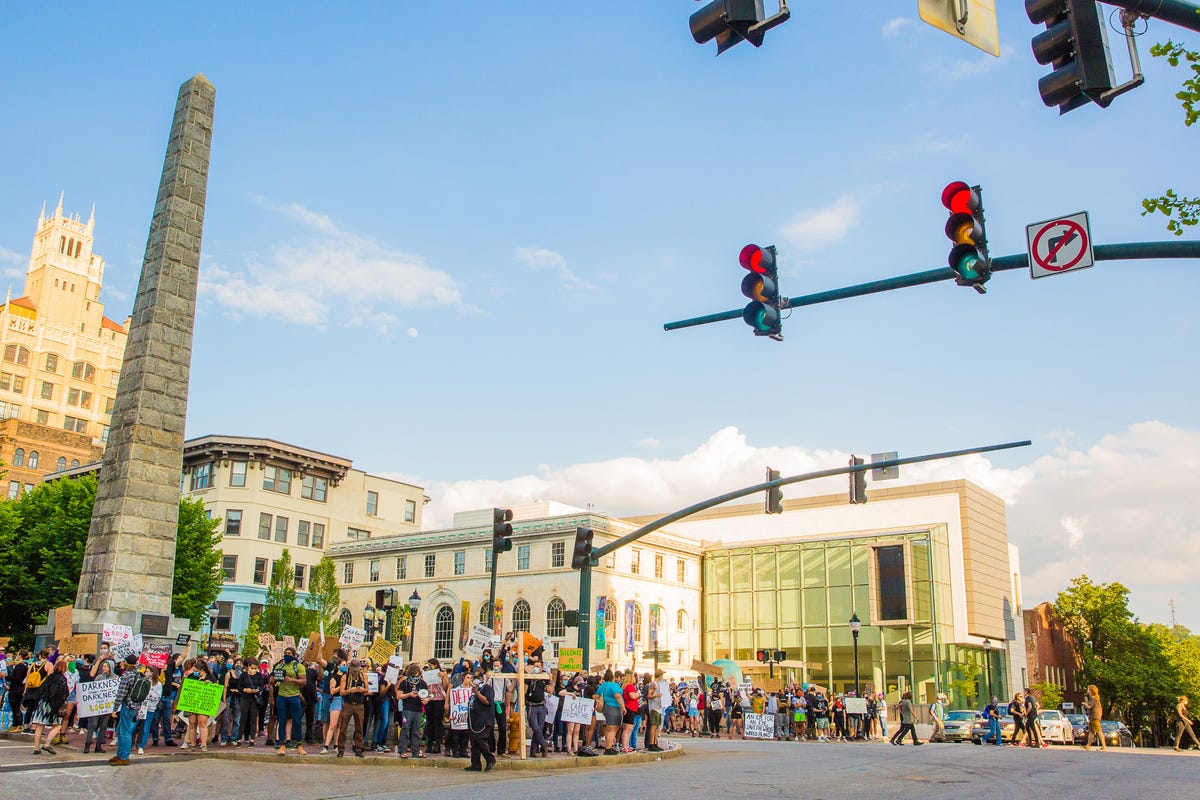 Protesters occupied the space around the Vance Memorial, staying on the sidewalk and peacefully demonstrating for all who drove through town. The protest here has been growing for days, and this would be the first night with an official curfew order, for 8 p.m., from the mayor.