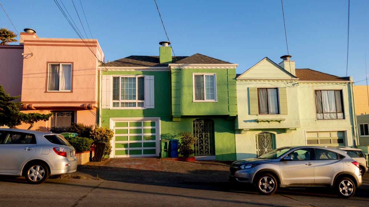 Colorful row houses with overhead power lines running to them.