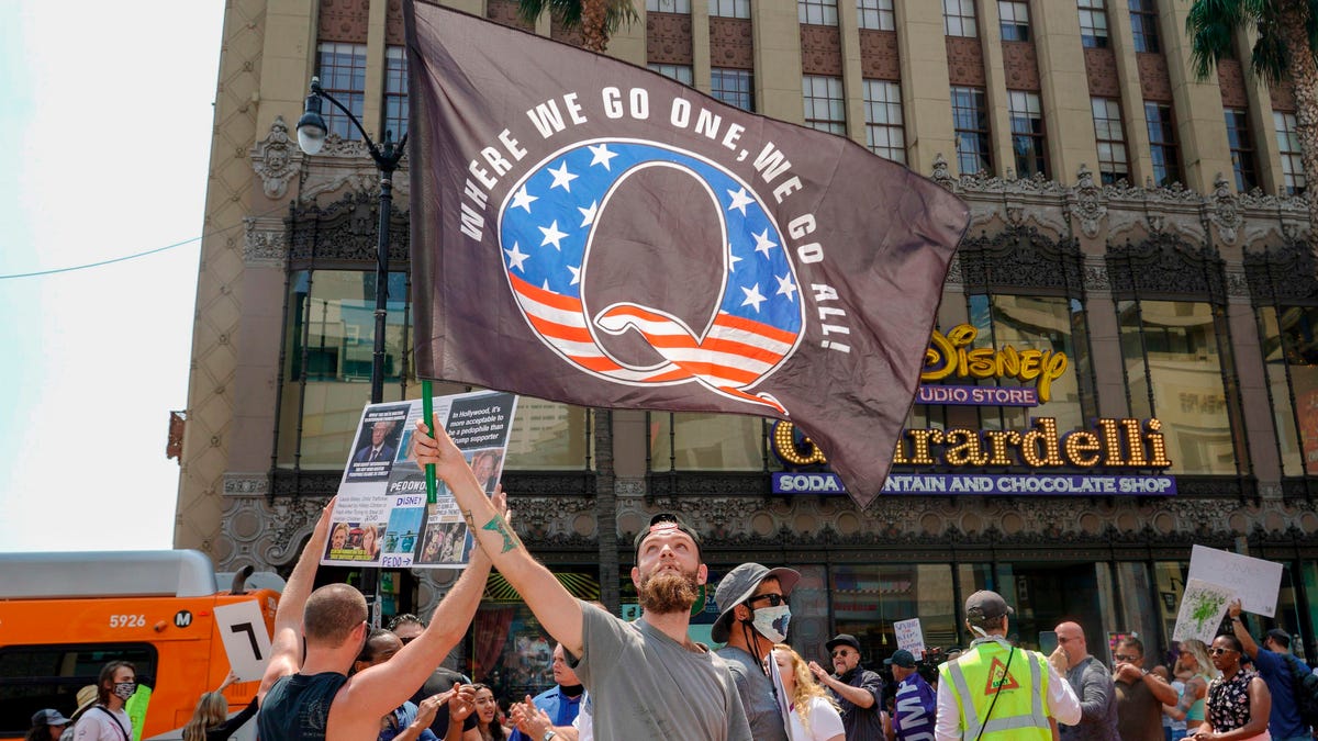 Man waves a QAnon flag
