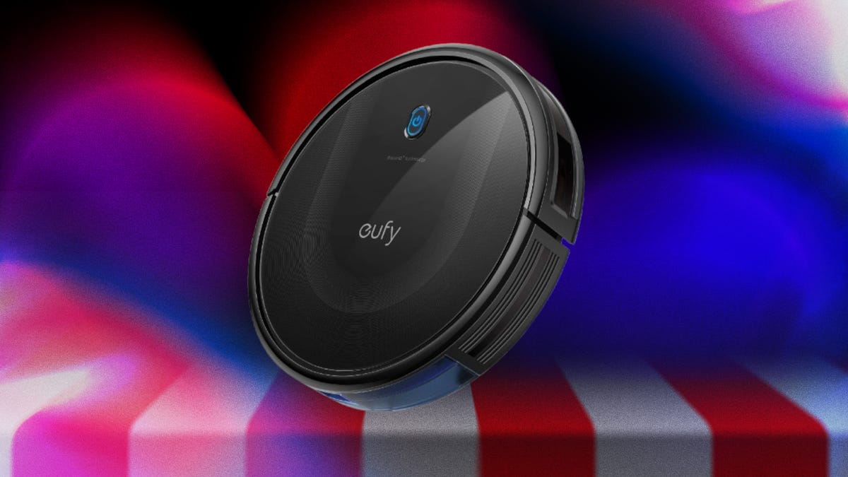 A black robot vacuum against a purple and orange gradient CNET background.