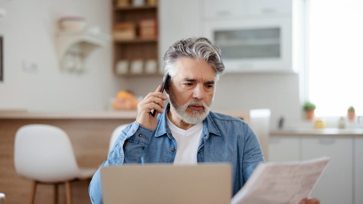 Man on a call with paper