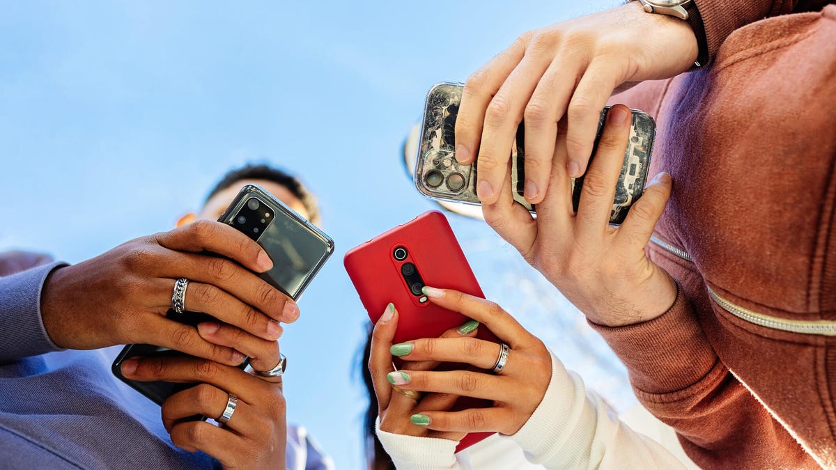 three teens with phones