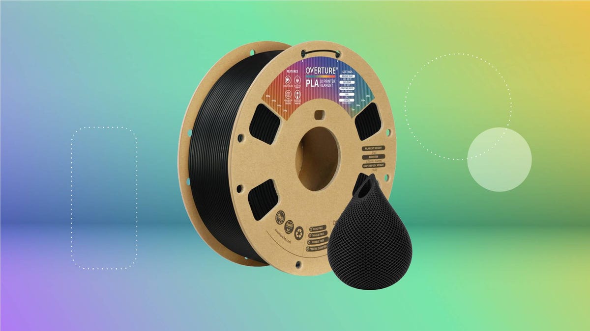 A spool of black 3D printing filament against a green gradient CNET background.