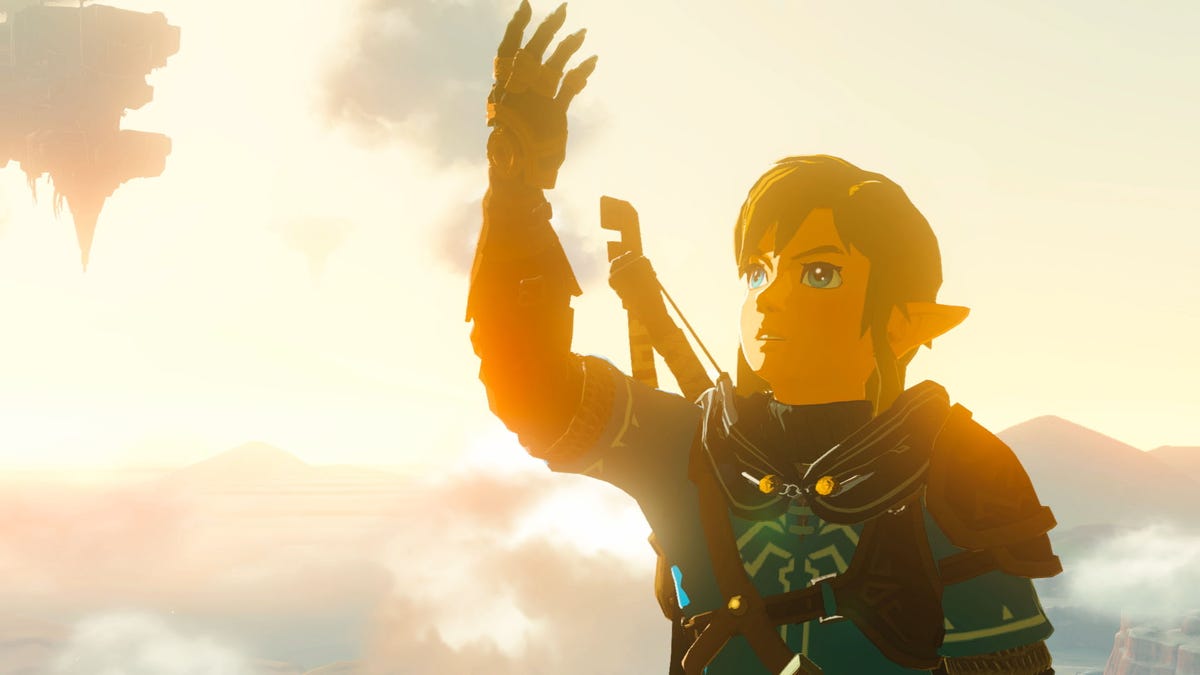 Link holds up his arm and gazes in wonder at his gauntlet in The Legend of Zelda: Tears of the Kingdom