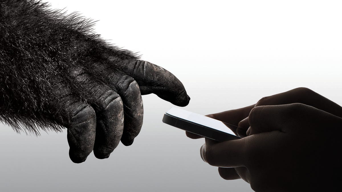 Gorilla hand reaching toward smartphone screen