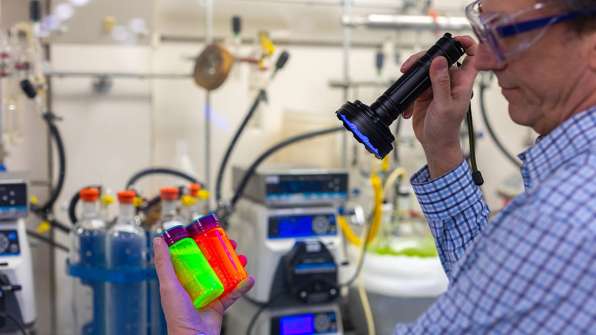Red and green vials glow with quantum dots in a laboratory.