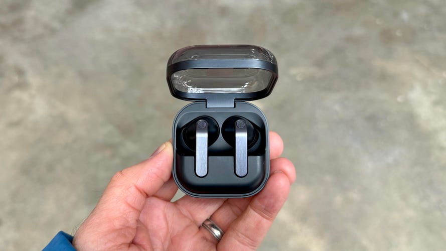 The black version of the Samsung Galaxy Buds 4 Pro held in a hand with the lid of their case open