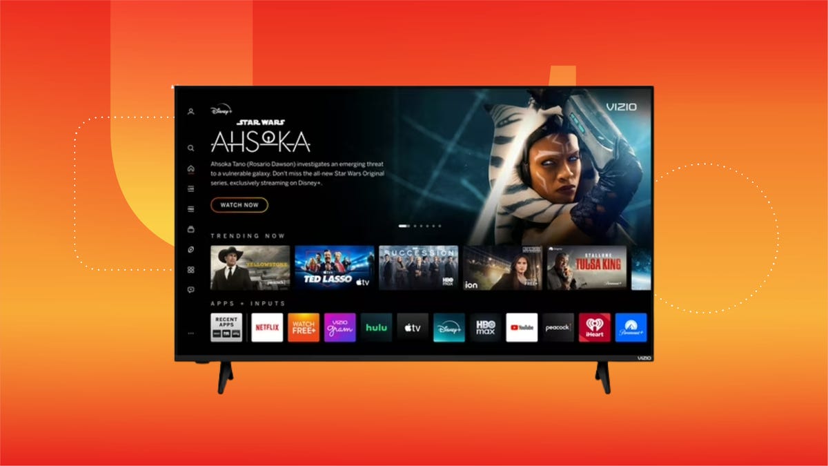 The Vizio 50-inch TV is shown against a gradient orange and red background.