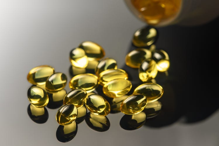 A handful of supplements on a gray background 