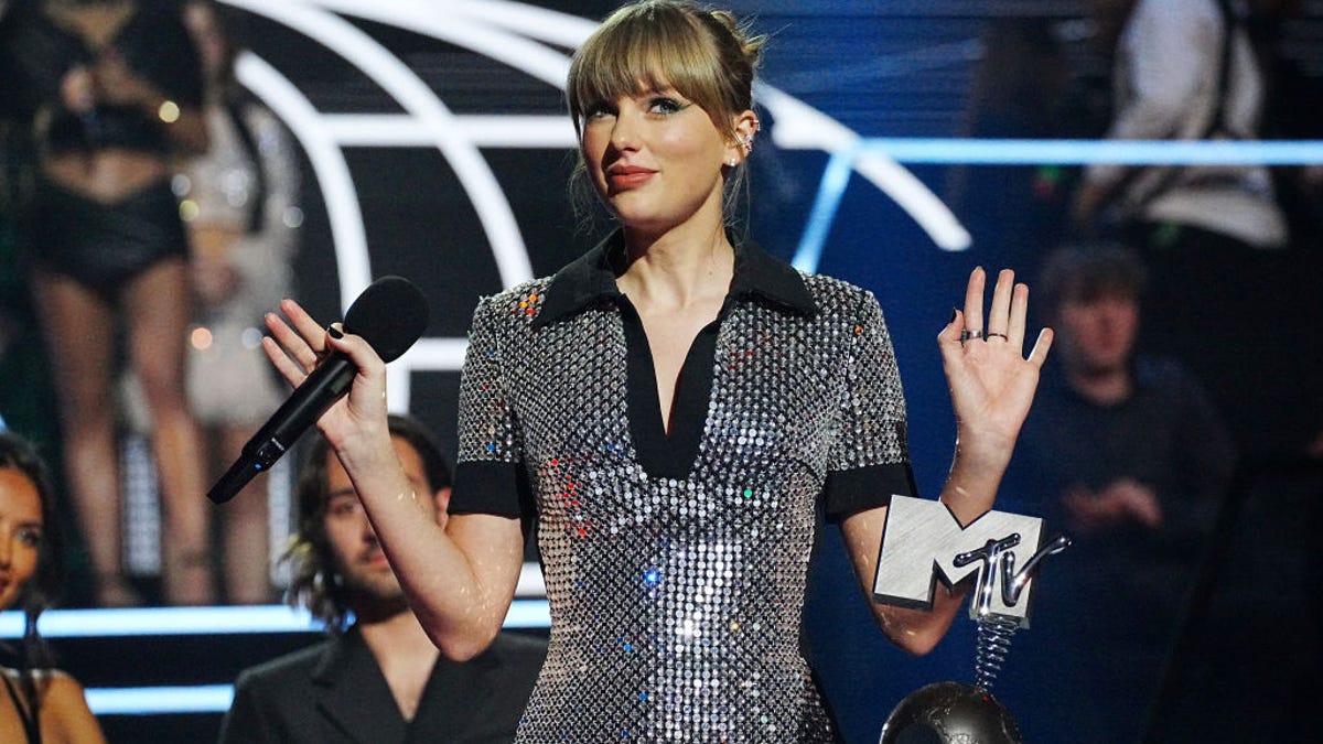 Dressed in a sparkling silver dress, Taylor Swift accepts an award on stage during the MTV Europe Music Awards in Duesseldorf, Germany, on Nov. 13.