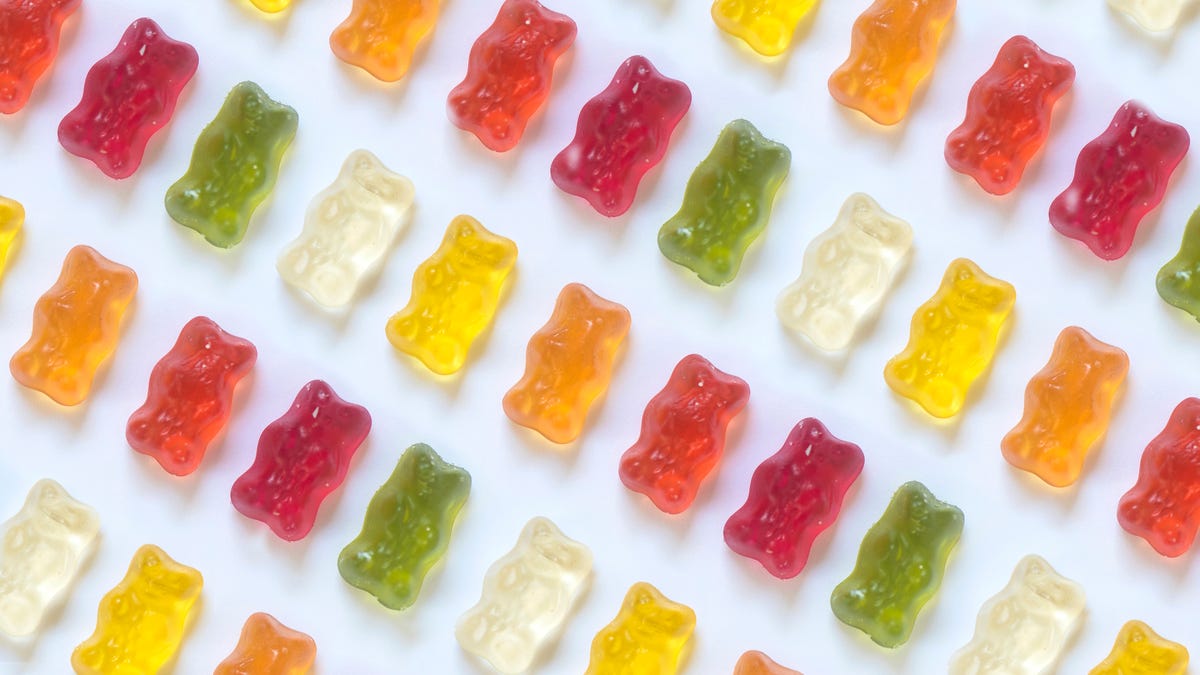 A close-up on green, red and clear gummy bears.