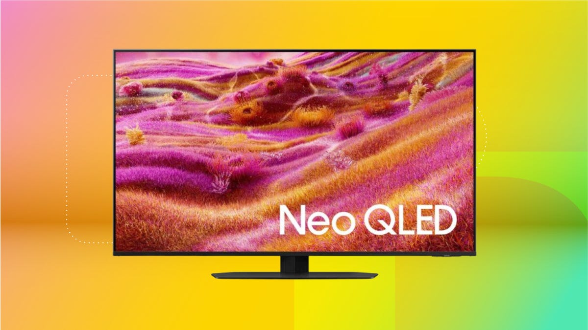 Flastscreen Samsung QN90F with pink wallpaper against coral, yellow and mint background.