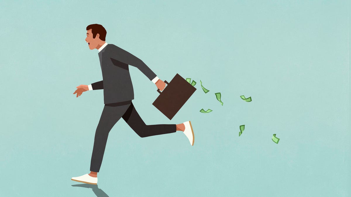 A pictiure of a guy running away with a suitcase full of cash.