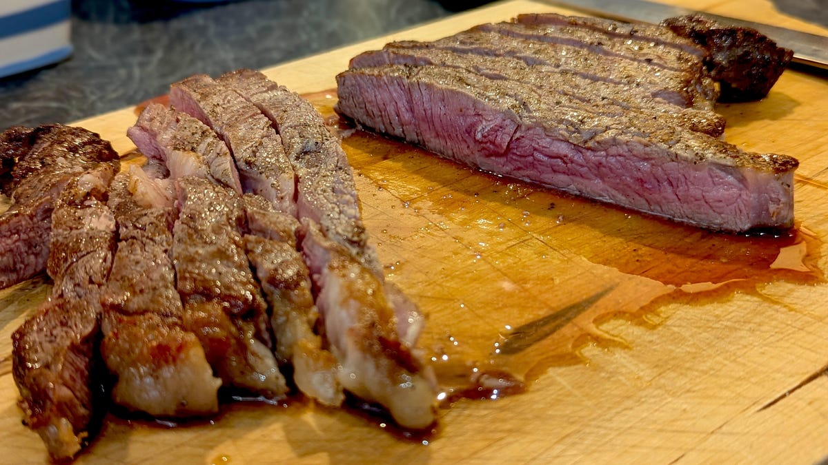 steak sliced on a wooden cutting board