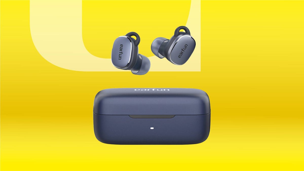 A pair of blue earbuds against a yellow gradient CNET background.