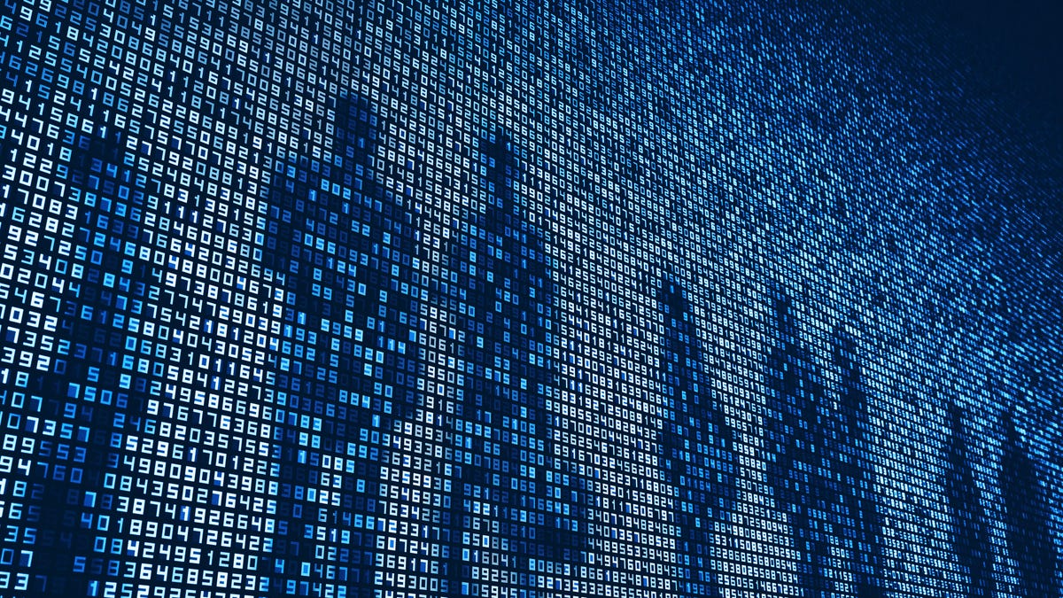 Silhouettes of people on a screen dark digital screen covered in bright numbers.