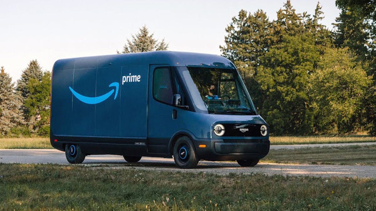 A blue Rivian electric van with an Amazon logo on the side