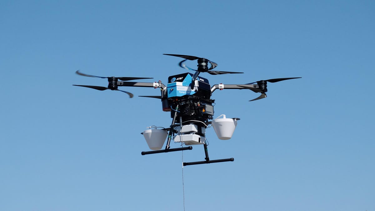 An AT&T flying COW drone with 5G network equipment flies in a blue sky