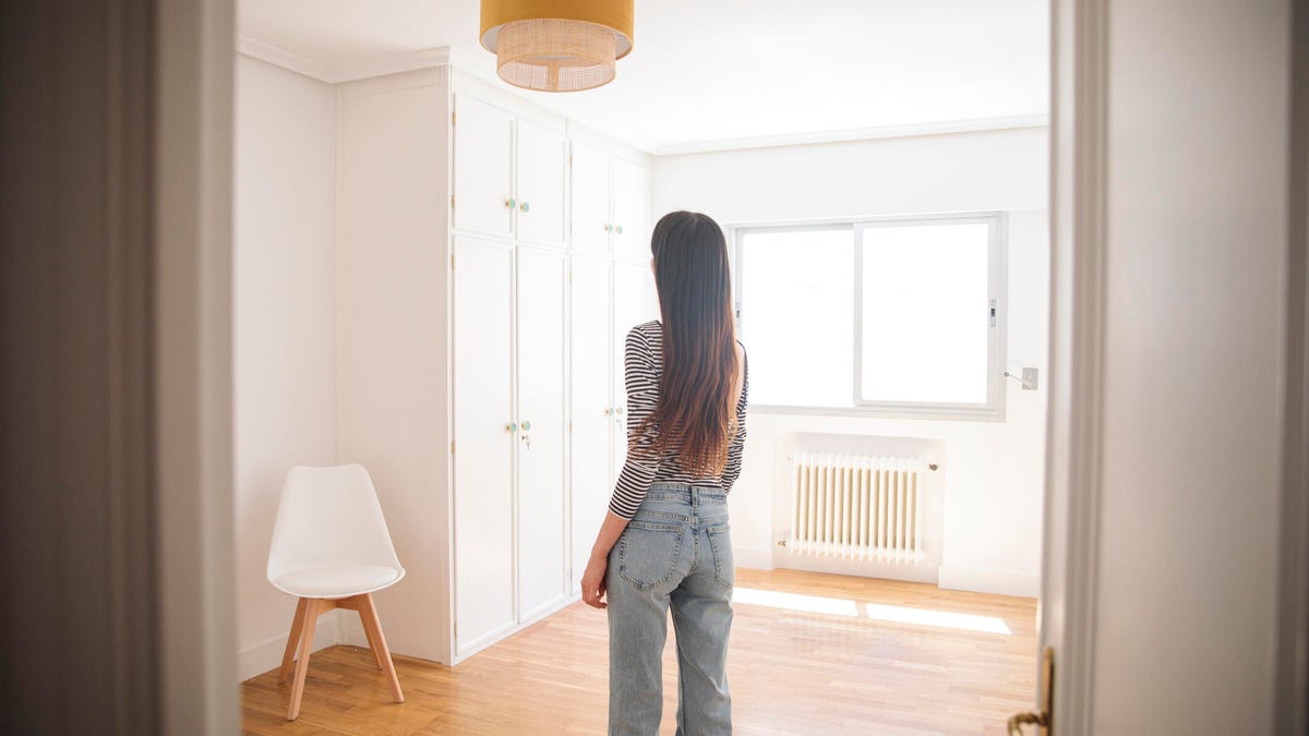 Woman looking at bedroom during a house tour