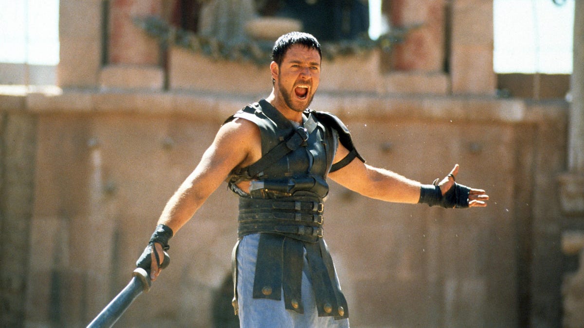 russell crowe holds a sword in a scene from Gladiator