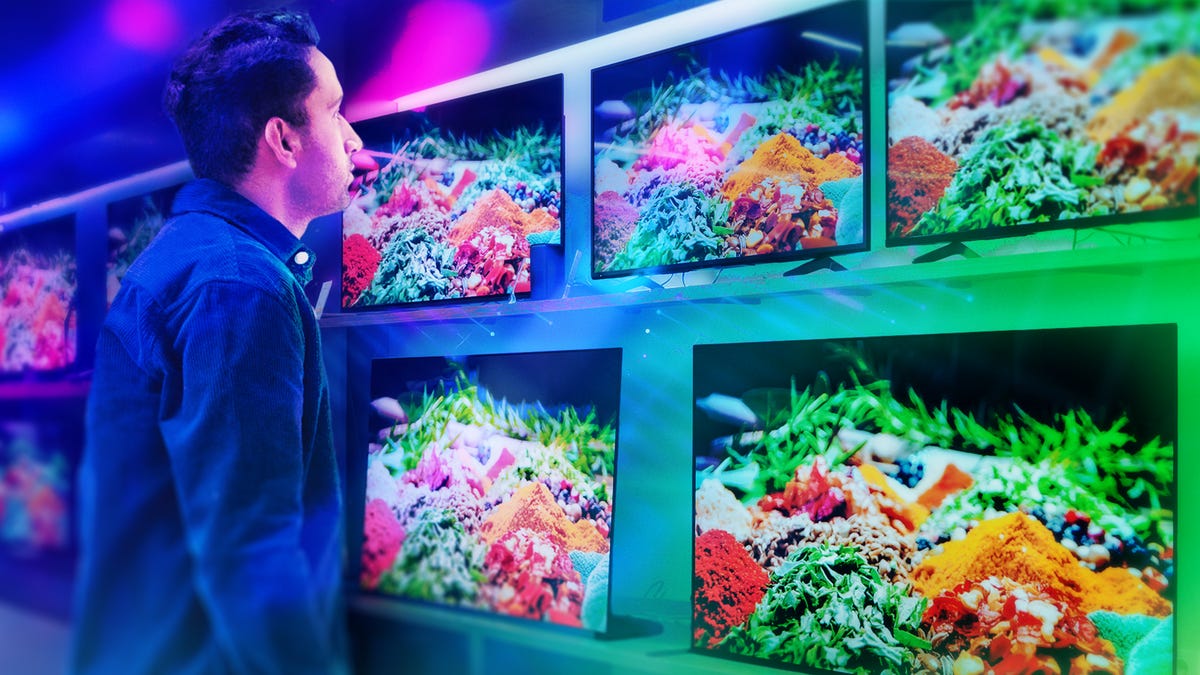 Shopper looks at different TVs on display.