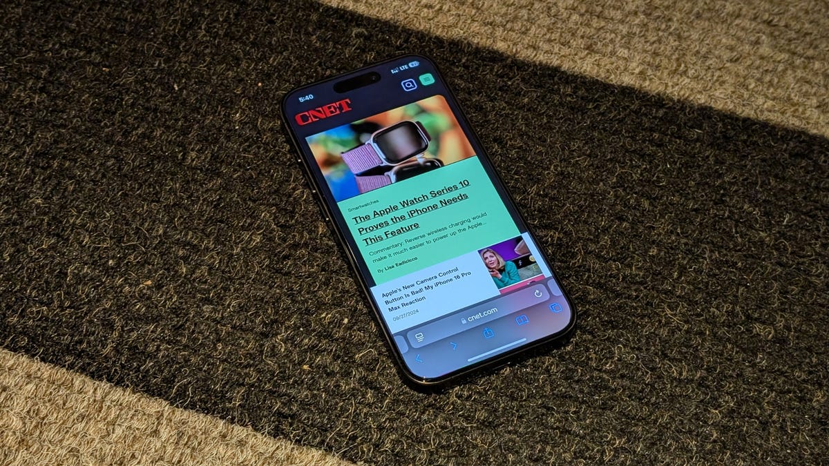 iPhone 15 Pro kept on carpet with safari app open and a tab open
