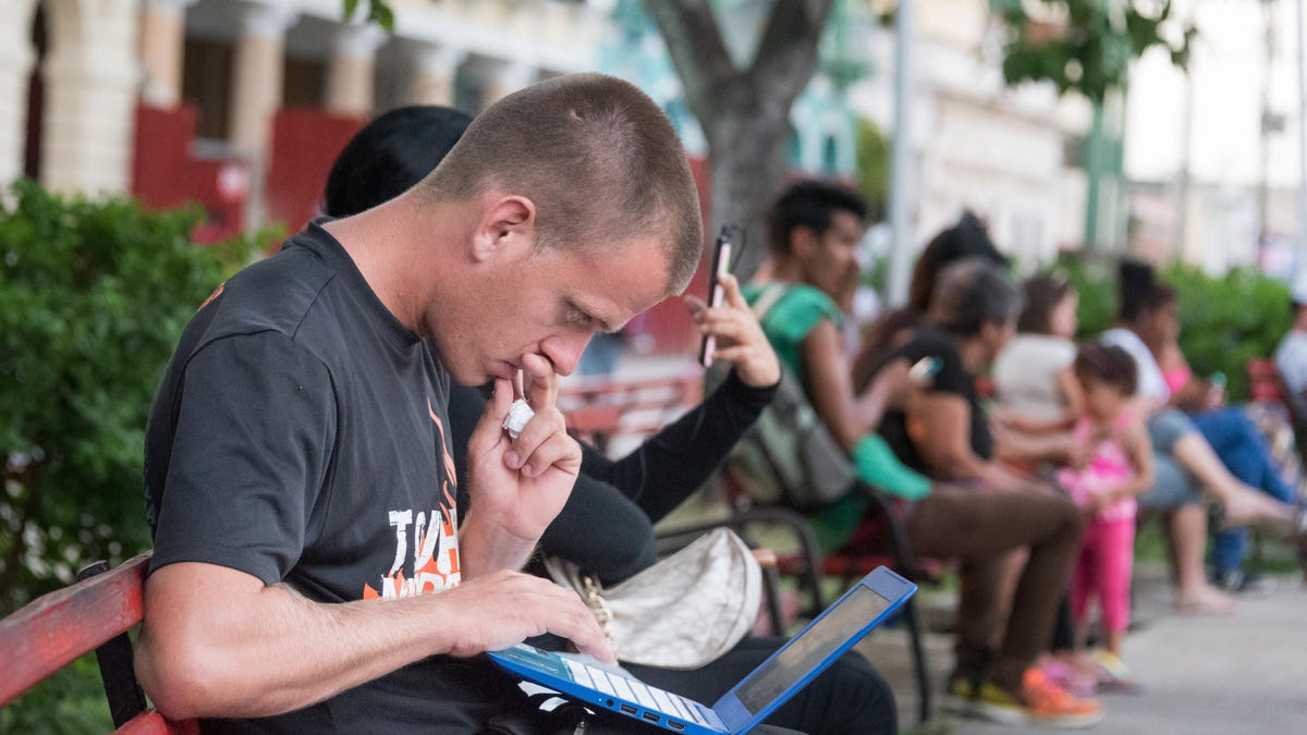 Cuban people connecting to the internet via wifi in the