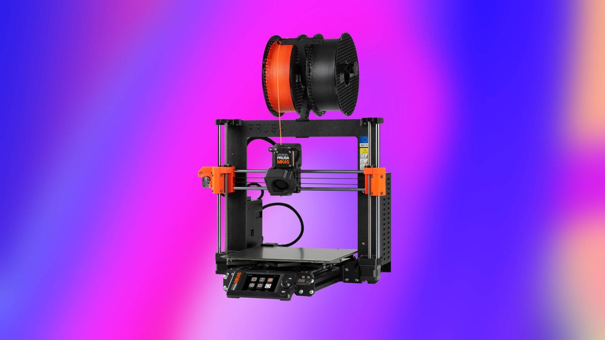 A black Prusa 3D printer against an abstract blue and pink background.