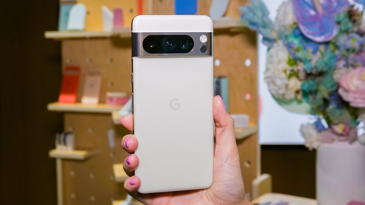 The Pixel 8 Pro behind held in someone's hand