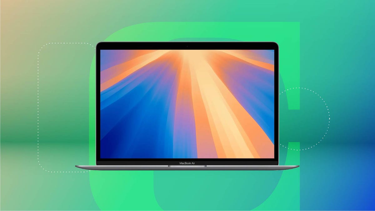 An open Apple laptop against a green CNET background.