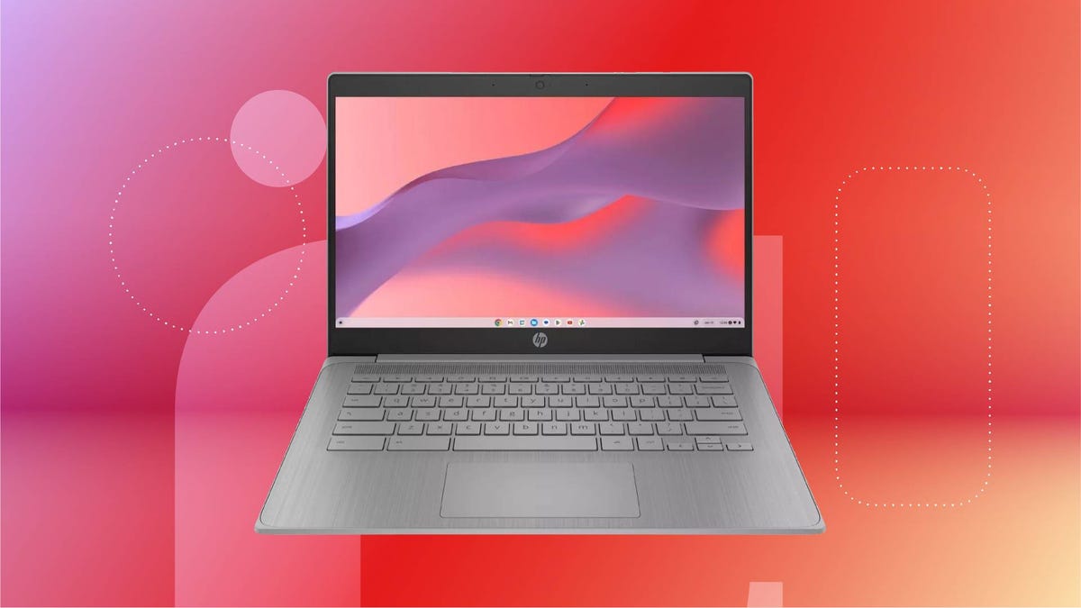 An open gray laptop against a red gradient CNET background.