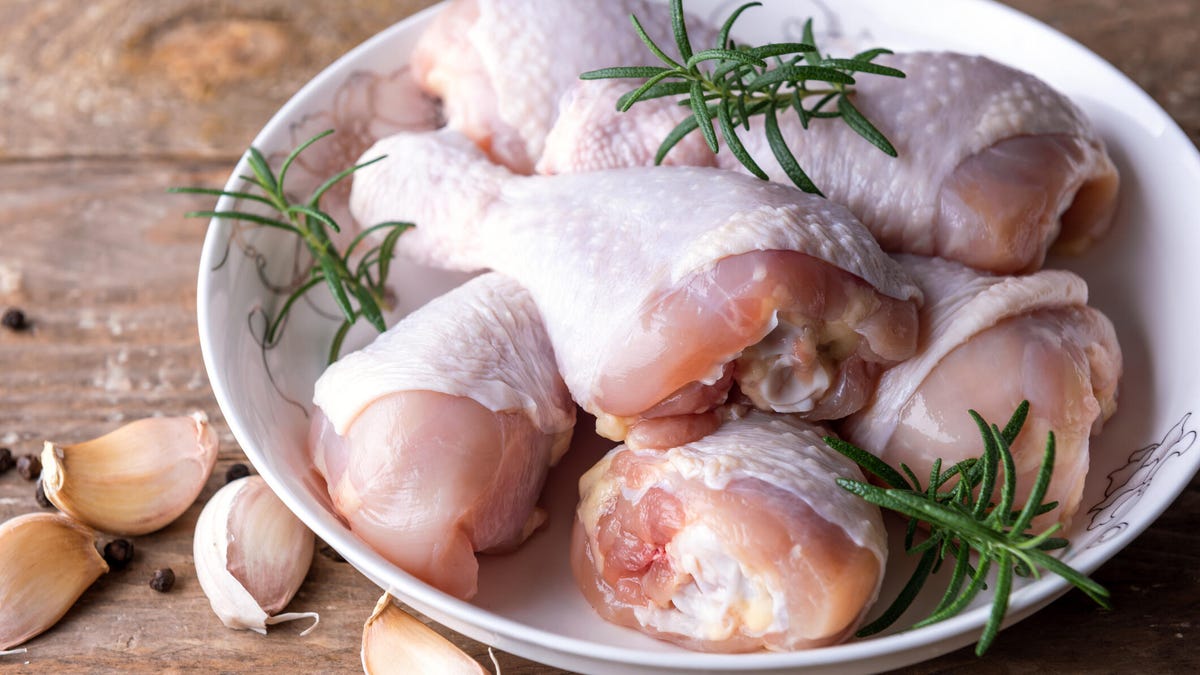 Raw uncooked chicken legs with spices drumsticks, meat with ingredients for cooking