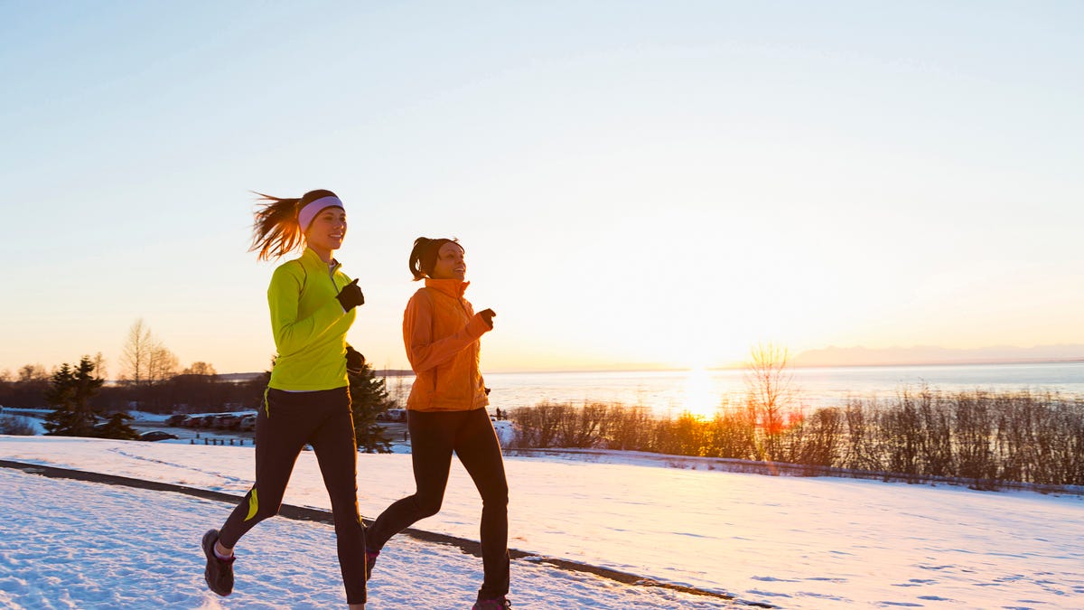 Two women running in the winter.
