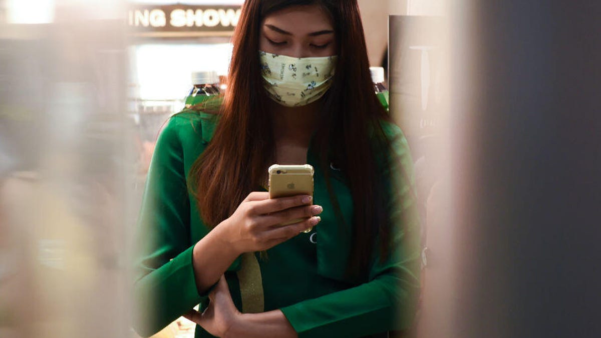 Amid the global scare over the coronavirus, a woman wears a mask at an airport in Thailand.