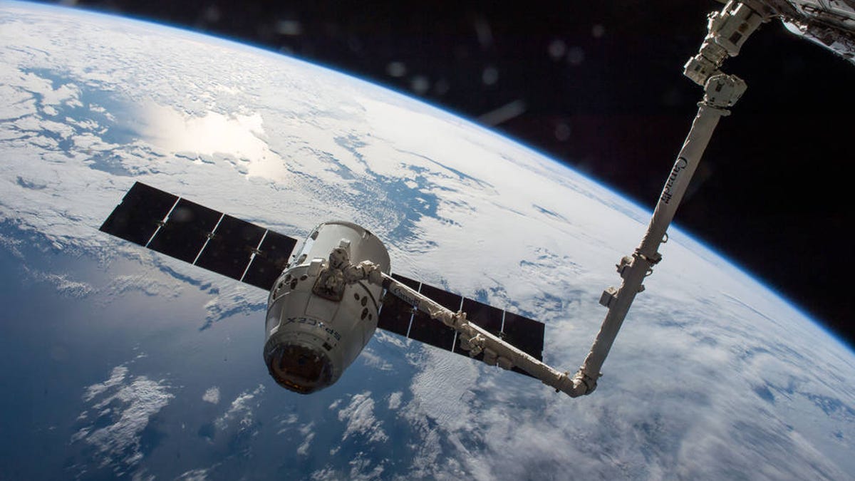 The Dragon capsule hooks up with the ISS.