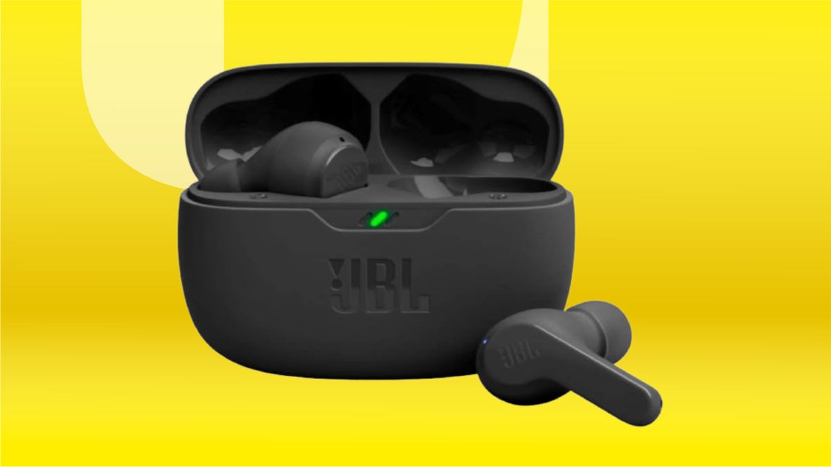 black JBL earbuds in charging case against yellow background