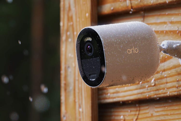 The Arlo Go 2 cam mounted to a wood siding in the rain.
